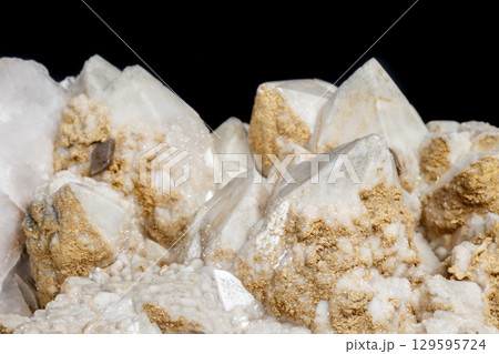 Macro mineral stone Snow quartz with calcite on a black background Macro mineral stone Snow quartz with calcite on a black background 129595724