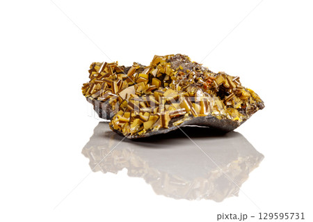 Macro mineral stone yellow Wulfenite on a white background 129595731