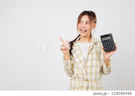Asian employee pointing confidently while holding calculator and showing another calculator to emphasize tax planning and accountant responsibility. isolated studio white background 129596449