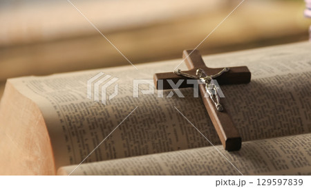 Wooden Jesus Cross on Old Book Wooden Jesus Cross on Old Book 129597839