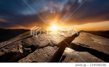 Cracked ancient stone revealing golden light at sunrise, symbolizing hidden truths and revelations 129598200