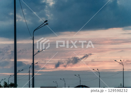 Silhouetted Streetlights Against a Dramatic Sky Silhouetted Streetlights Against a Dramatic Sky 129598232