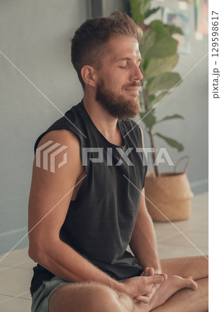 Man meditating in seated yoga pose. Concept of yoga, mindfulness and inner focus. 129598617