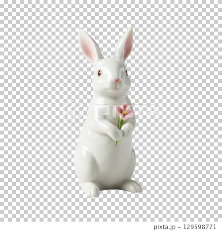 Charming white ceramic rabbit figurine holding a delicate pink flower, perfect for easter decor 129598771
