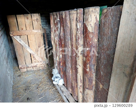 Rustic Barn Interior Showcasing Wooden Panels in a Village Setting During Daylight Hours Rustic Barn Interior Showcasing Wooden Panels in a Village Setting During Daylight Hours 129600289