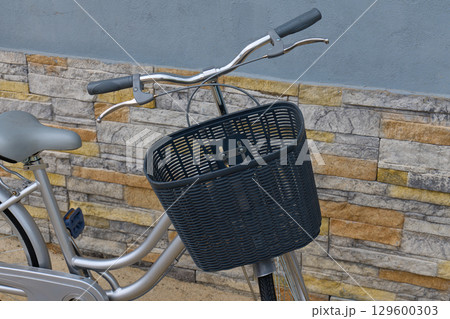 bicycle with a black wicker basket 129600303