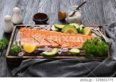 grilled whole salmon fillet on wooden board 129601774