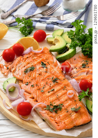 grilled salmon fillet on circle wooden board grilled salmon fillet on circle wooden board 129601780