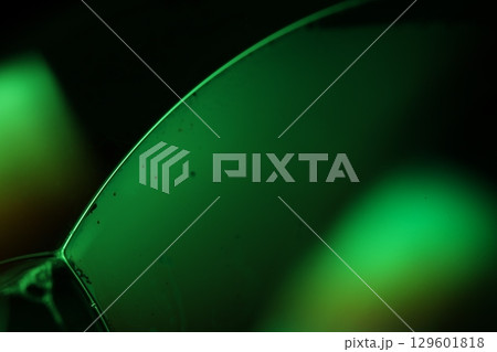 Green liquid film, fantastic bubbles connections, fluid movement, dark fantastic background, transparent oil, green ink 129601818