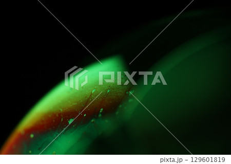 Green liquid film, fantastic bubbles connections, fluid movement, dark fantastic background, transparent oil, green ink 129601819