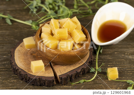 cheese and honey closeup, fresh yellow cheese and viscous sweet natural bee honey 129601968