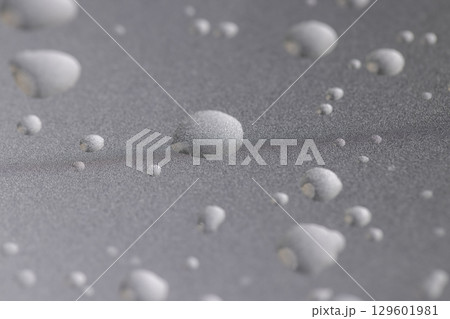 smooth silver colored metal surface covered with drops of pure water, wet silver-colored metal painted to protect aluminum alloy and metals, close up 129601981