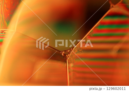 Orange coloured liquid surface, fluid effect, bright chemistry, geometric shapes 129602011