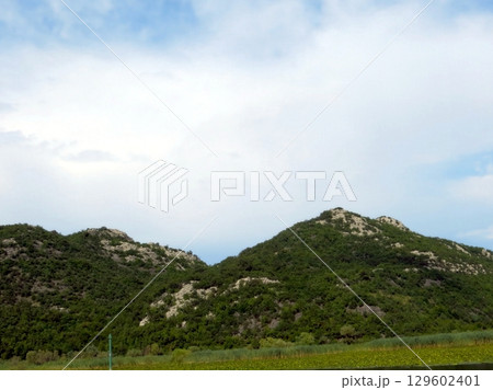 Discover the tranquility of Lake Skadar amidst the majestic mountains of Montenegro 129602401