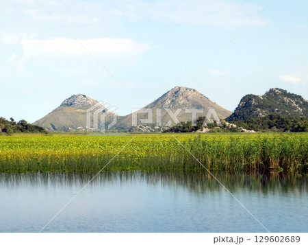 Exploring the Tranquil Beauty of Skadar Lake and Its Majestic Mountains in Montenegro Exploring the Tranquil Beauty of Skadar Lake and Its Majestic Mountains in Montenegro 129602689
