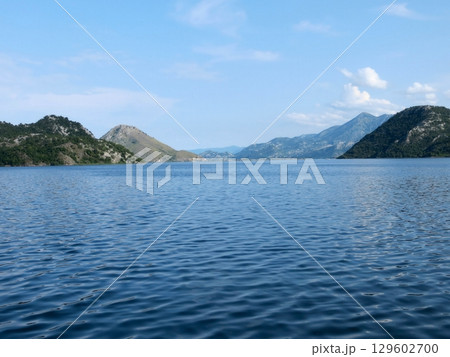 Explore the Serene Beauty of Skadar Lake in Montenegro With Majestic Mountains Surrounding Explore the Serene Beauty of Skadar Lake in Montenegro With Majestic Mountains Surrounding 129602700