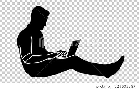 Silhouette of a man sitting on the floor and using a laptop Silhouette of a man sitting on the floor and using a laptop 129603387