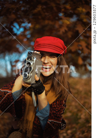 happy trendy 40 years old woman in red hat 129603877