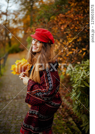happy modern woman in red hat walking happy modern woman in red hat walking 129603878