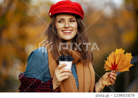 happy stylish female in jeans shirt and red hat 129603879
