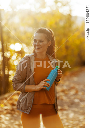 happy elegant woman in fitness clothes in park happy elegant woman in fitness clothes in park 129604274