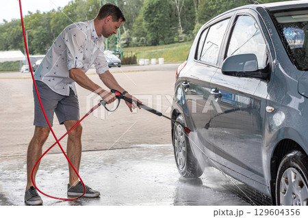 Car wash. Car cleaning foam soap bubbles. Spray water vehicle shine wet. Car wash. Car cleaning foam soap bubbles. Spray water vehicle shine wet. 129604356