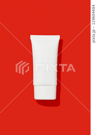 Blank white cosmetic plastic tube on red background. Christmas Valentines day sale concept 129604684
