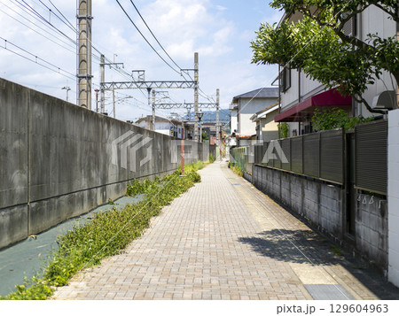 鉄道の高架線横と路地の風景 129604963