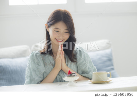 ケーキを食べる若い女性　 129605956