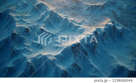 Aerial shot of a snow-covered mountain range, revealing intricate textures and a soothing cool blue atmosphere 129606044