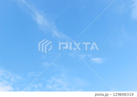 beautiful blue sky and white fluffy group of clouds with sunrise in the morning, natural background 129606319