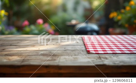 An outdoor table adorned with a colorful tablecloth, basking in sunlight, perfect for a delightful spring picnic 129606811