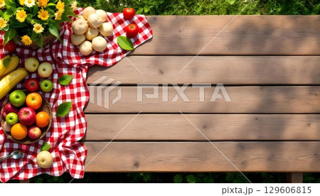 A spring-inspired picnic table adorned with fresh fruit and cheerful flowers, setting a festive mood for outdoor dining 129606815