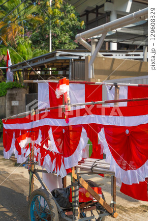 インドネシア独立記念日を祝う赤白の旗を売る屋台(移動販売) 129608329