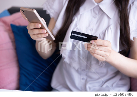 スマホでオンラインショッピングをする日本人女性の手元 スマホでオンラインショッピングをする日本人女性の手元 129608490