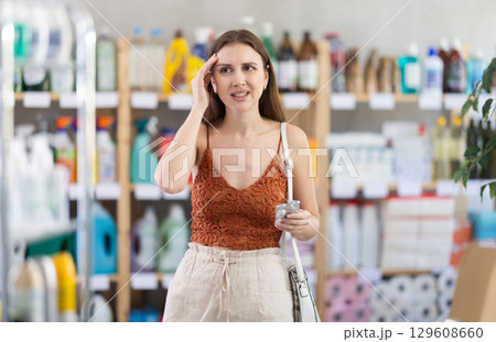 Girl suffers from headache, holds on to sore spot and tries to help herself using painkillers tablet Girl suffers from headache, holds on to sore spot and tries to help herself using painkillers tablet 129608660