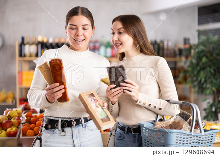 Women choose Spanish sweets in the store Women choose Spanish sweets in the store 129608694