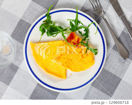 Omelette served with arugula on platter Omelette served with arugula on platter 129608718