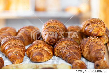 Showcase of traditional bakery shop with appetizing croissants Showcase of traditional bakery shop with appetizing croissants 129608736