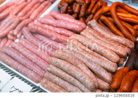 Sausages made of pork and chicken minced meat ready for grilling in meat department of store Sausages made of pork and chicken minced meat ready for grilling in meat department of store 129608816