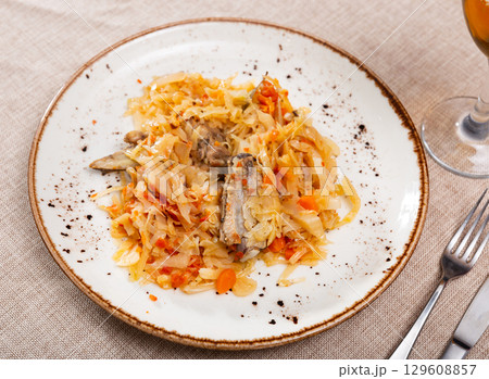 Delicious pork ribs stewed in gravy with sauerkraut close up Delicious pork ribs stewed in gravy with sauerkraut close up 129608857