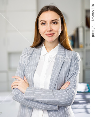 Portrait of positive smiling businesswoman in suit 129609110