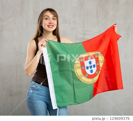 Young cheerful woman holding Portugal flag 129609376