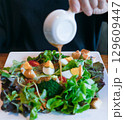 Boiled eggs with vegetables on wooden table. Salad for diet food 129609447