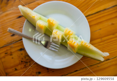 Sliced juicy melon served on platter Sliced juicy melon served on platter 129609558