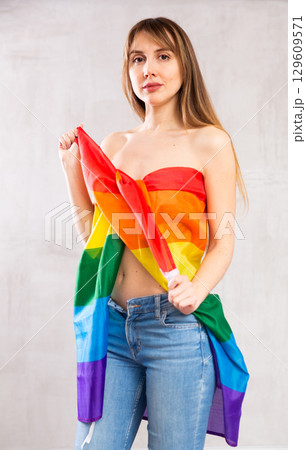 Young woman wrapped in LGBT flag 129609571