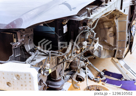 Car engine compartment exposed during repair process at an auto workshop Car engine compartment exposed during repair process at an auto workshop 129610502