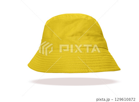 A yellow hat floats on a white background. 129610872