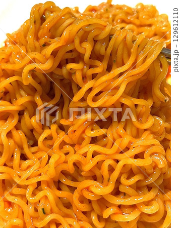 Spicy buldak ramyeon with fiery hot sauce and chewy noodles, delivering an intense, flavorful kick in every bite. A perfect choice for those who crave bold, spicy Korean comfort food. 129612110