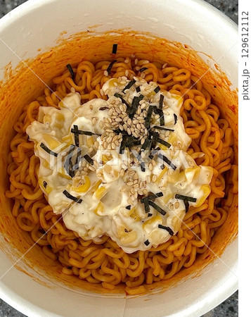 Spicy buldak ramyeon with fiery noodles paired with creamy, savory corn cheese, creating a perfect balance of heat and rich flavors in every satisfying bite. A must-try for spicy food lovers. 129612112